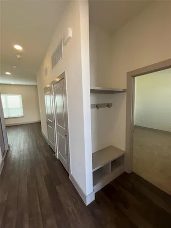 a view of hallway with wooden floor