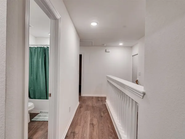 a bedroom with a bed and a night stand