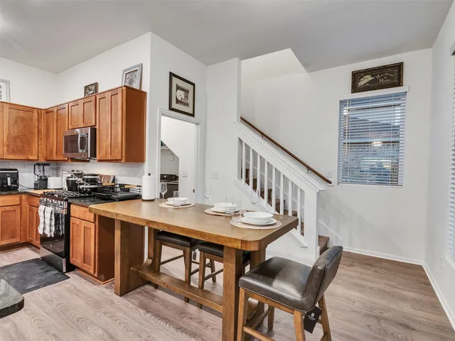 a kitchen with stainless steel appliances granite countertop a stove a microwave and cabinets