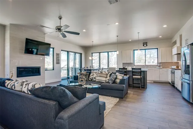 a living room with furniture kitchen view and a fireplace
