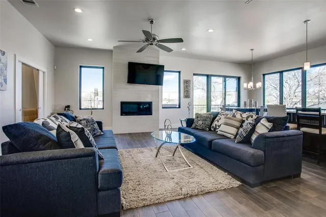 a living room with furniture fireplace and a flat screen tv