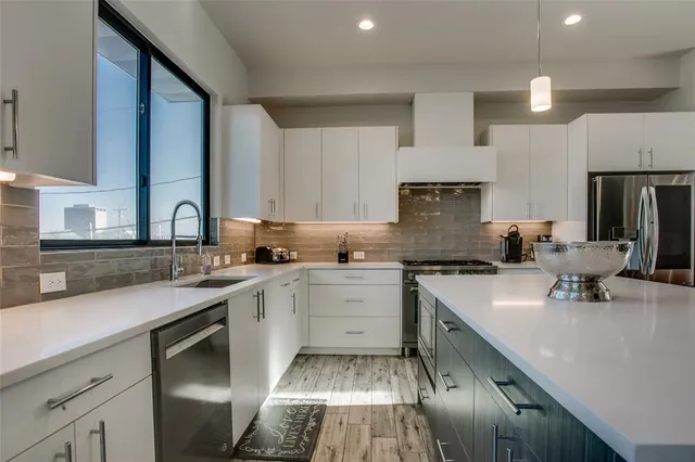 a kitchen with a sink stove and cabinets
