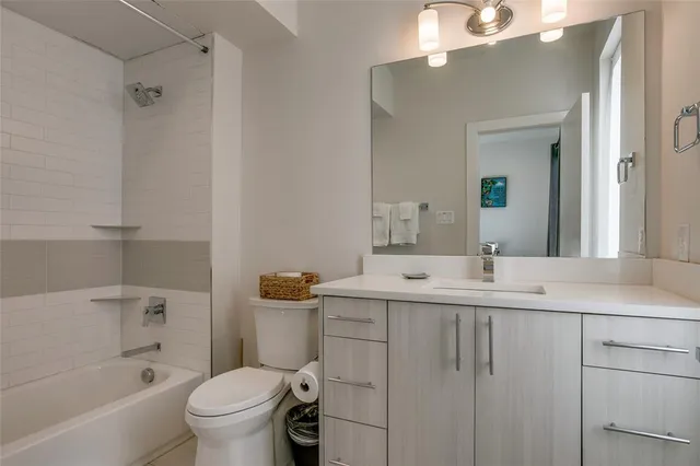 a bathroom with a tub sink and mirror