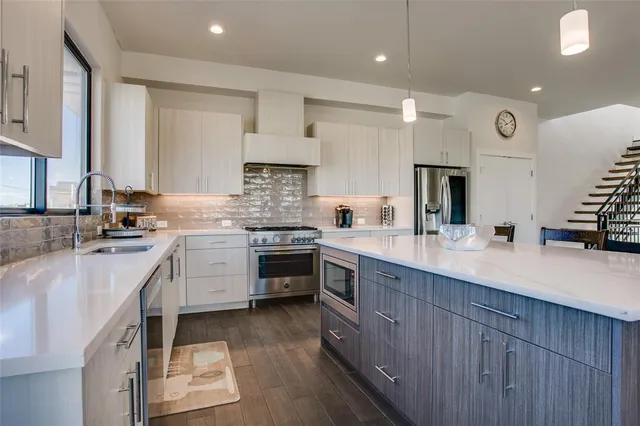 a kitchen with a sink stove and cabinets