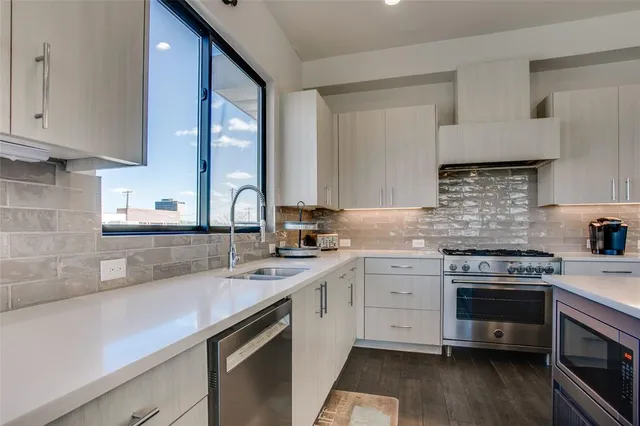 a kitchen with a sink stove and cabinets