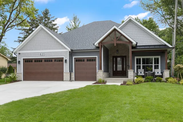 a view of a house with a yard and front view of a house