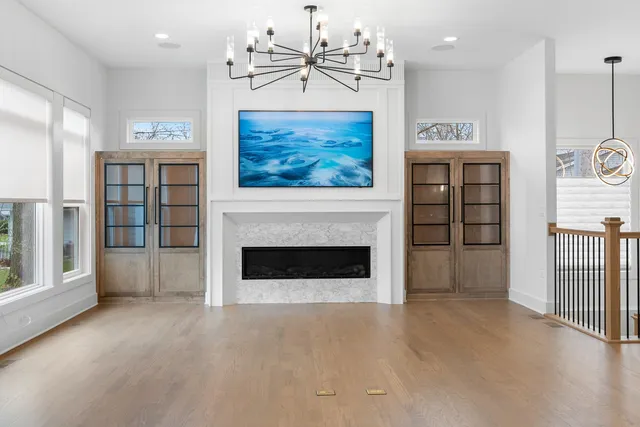 a view of a livingroom with a fireplace and window