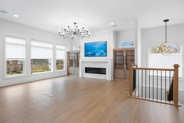 a view of an empty room with a fireplace and a window