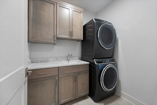 a utility room with sink dryer and washer