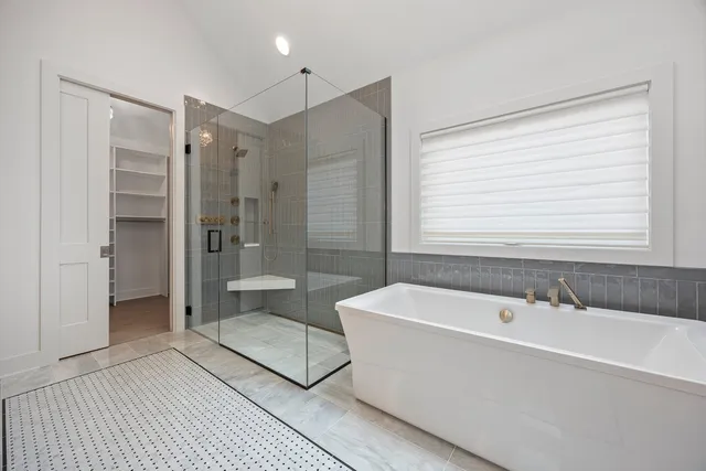 a spacious bathroom with a bathtub and a shower