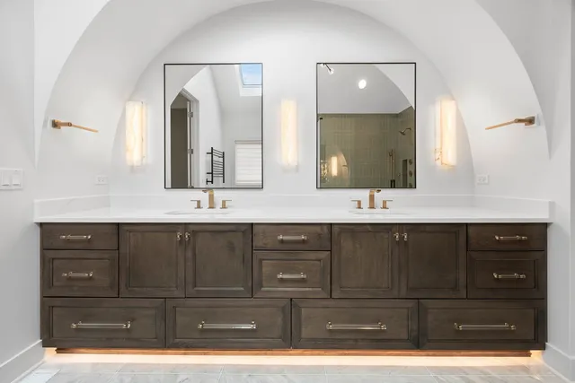 a bathroom with a double vanity sink and mirror