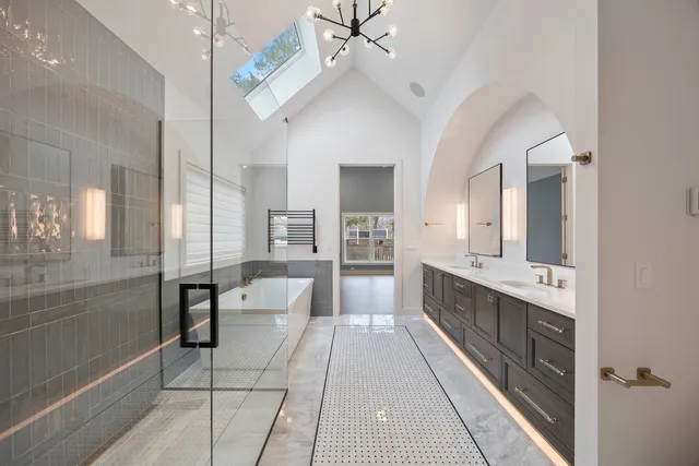 a large white kitchen with a large tub and sink