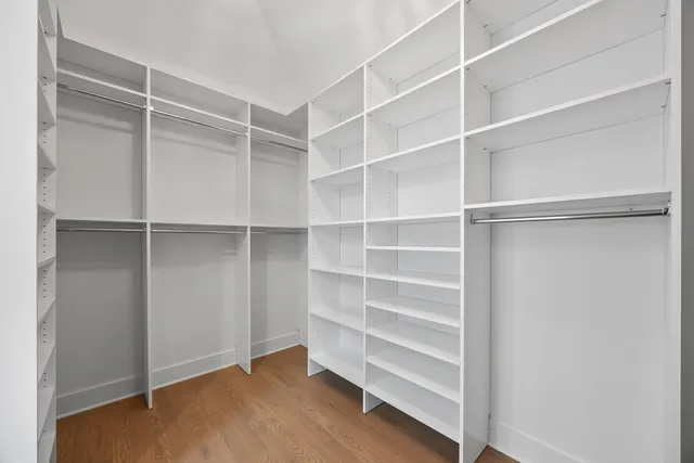 a view of walk in closet with empty racks