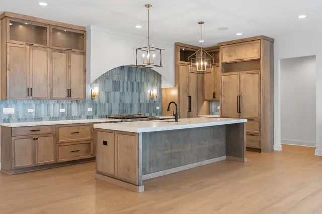 a kitchen with a sink stove and refrigerator