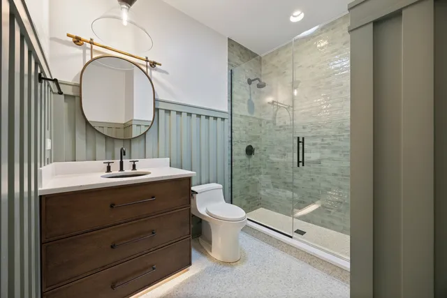 a bathroom with a toilet a sink and a mirror