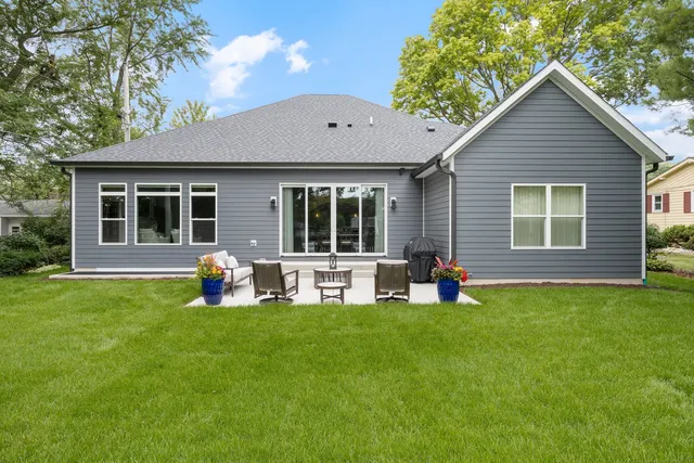 a view of a house with a yard and porch