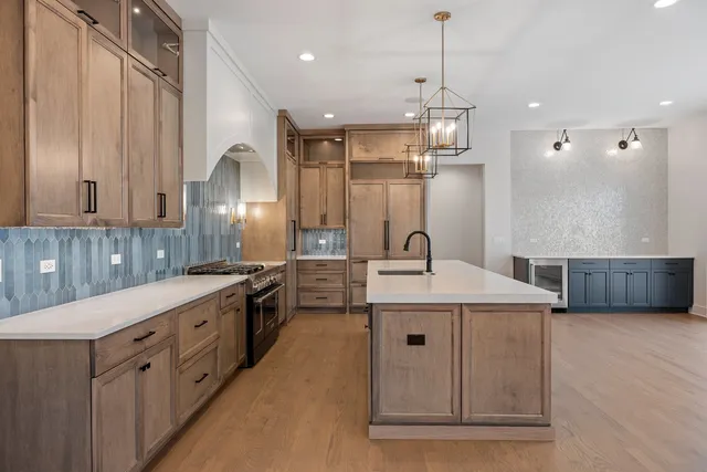 a large kitchen with kitchen island a sink a counter space and stainless steel appliances