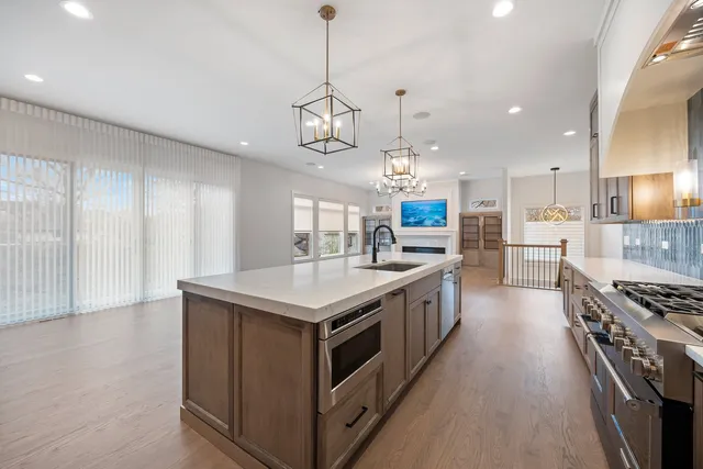 a kitchen with stainless steel appliances granite countertop a stove and a sink