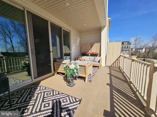 a view of balcony with chairs and wooden fence