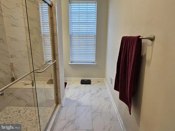 a bathroom with a shower and a mirror
