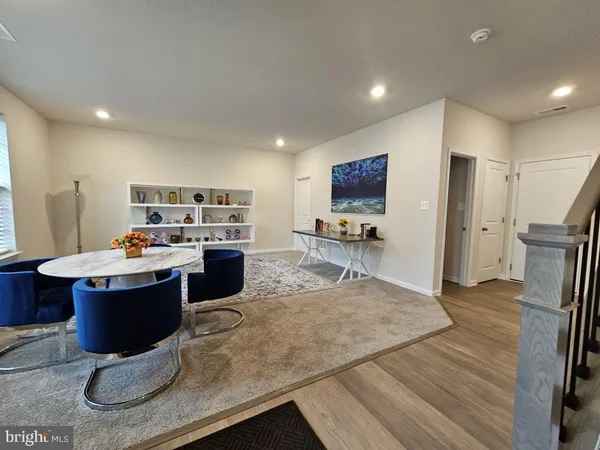 a large kitchen with a table and chairs