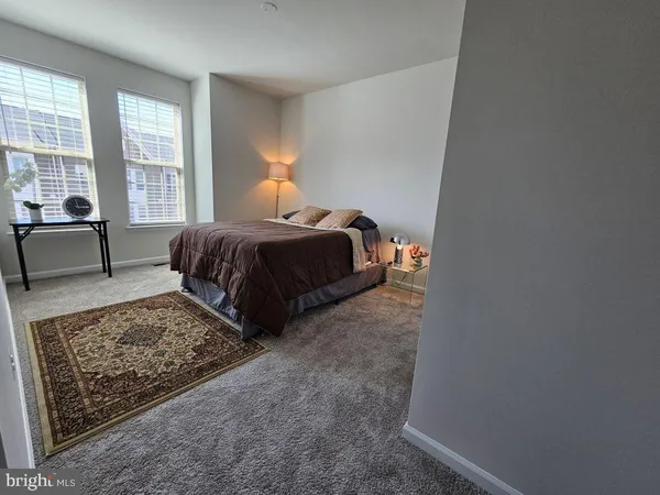 a bedroom with a bed and a couch next to a window