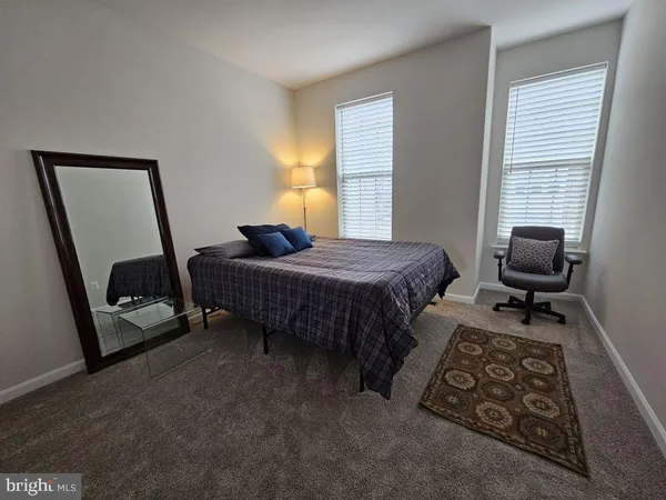a bedroom with bed and a window