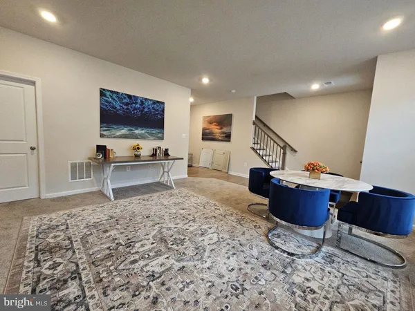 a living room with furniture and a rug