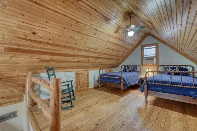 a large kitchen with stainless steel appliances wooden cabinets a sink and a stove