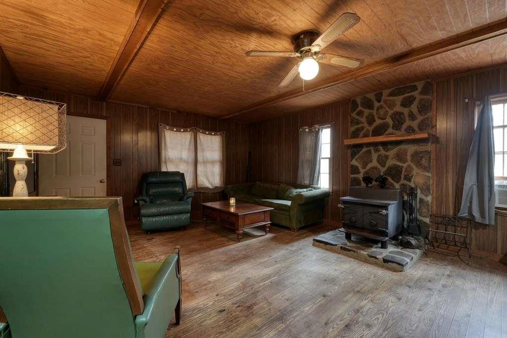 2479 Plum Orchard Road Clayton, GA 30525 - Photo 33 of 72 a living room with furniture a flat screen tv and gym equipment
