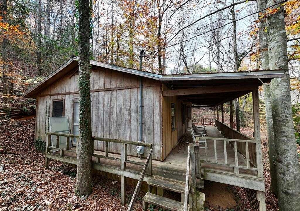 2479 Plum Orchard Road Clayton, GA 30525 - Photo 61 of 72 a view of a house with large windows and a table and chairs