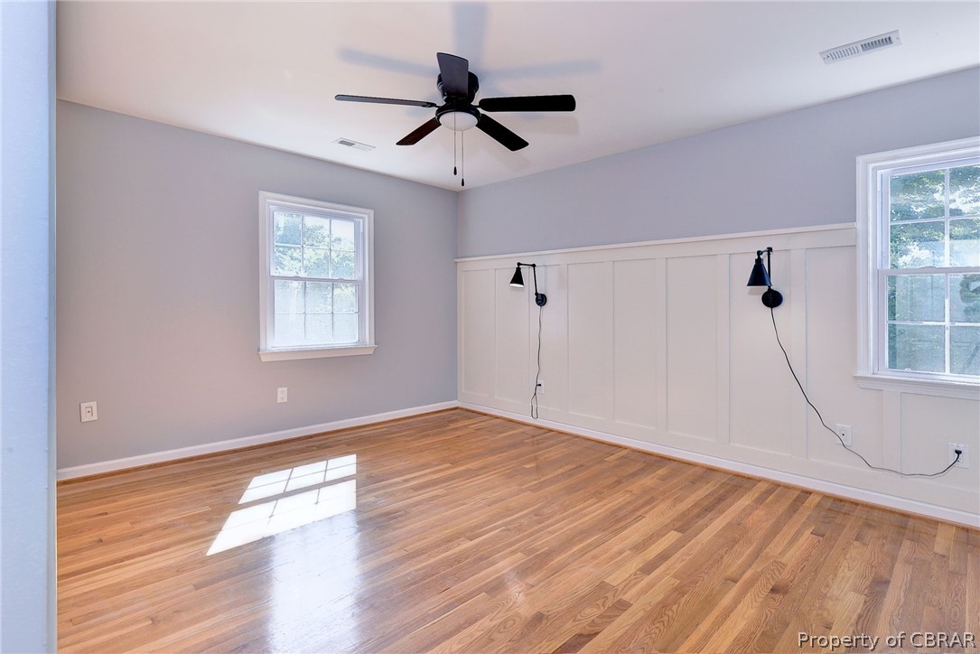 137 Wilderness Road Hampton, VA 23669 - Photo 37 of 45 Unfurnished room featuring a healthy amount of sunlight, ceiling fan, and light hardwood / wood-style flooring