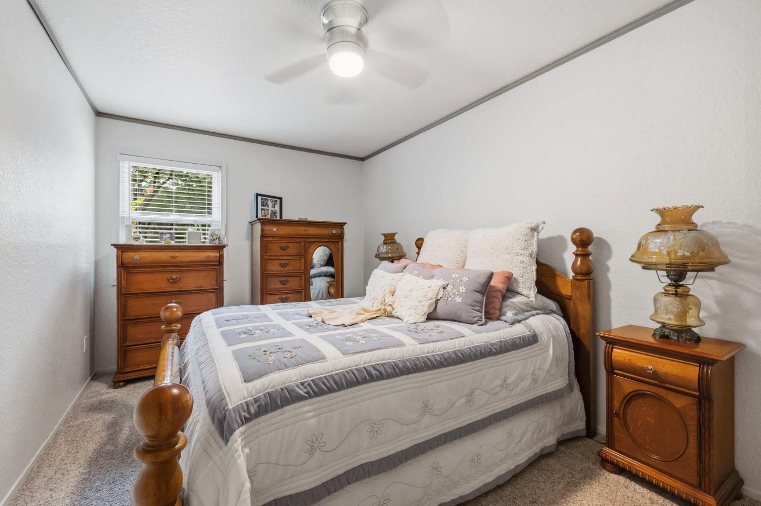 11460 Racetrack Road Sonora, CA 95370 - Photo 27 of 46 a bedroom with a bed and a chandelier