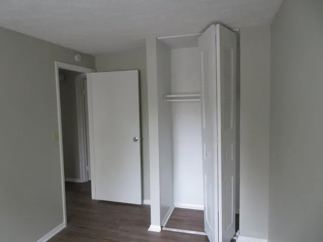 a view of walk in closet with wooden floor