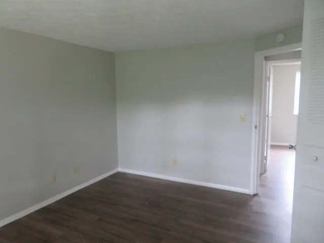 a view of an empty room and wooden floor