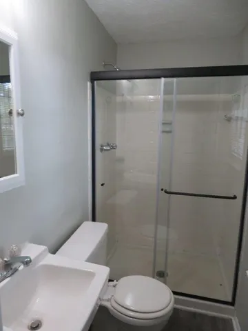 a white toilet sitting next to a bathroom sink