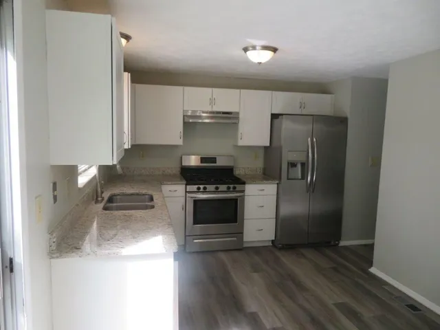 a kitchen with a refrigerator and a stove