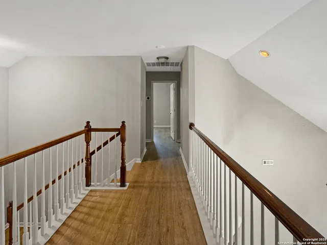 an empty room with closet and a ceiling fan