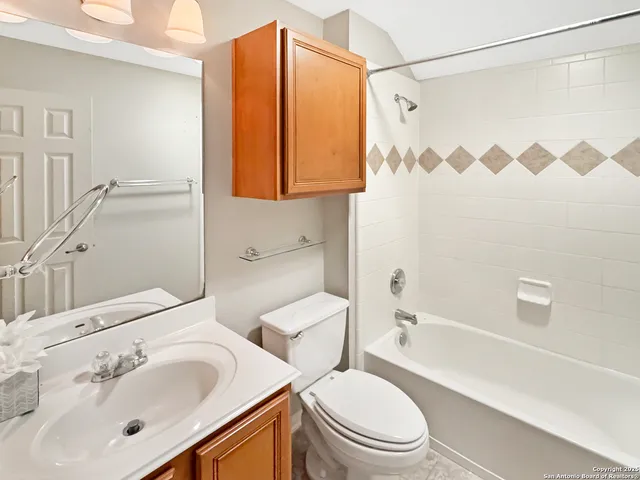 a kitchen with granite countertop a refrigerator stove top oven and sink