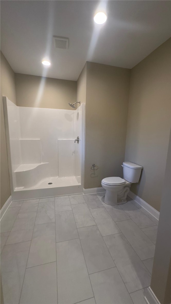 247 Vera Holliday Road Six Mile, SC 29682 - Photo 10 of 20 This clean bathroom features a shower and toilet with tiled flooring and recessed lighting.