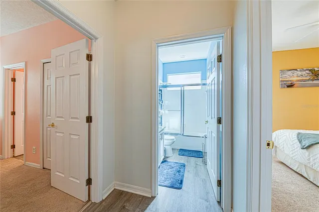 a spacious bedroom with a bed and a chandelier