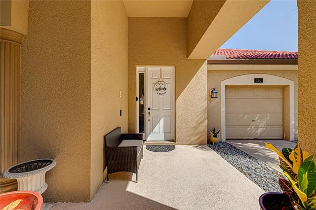a living room with a couch and a potted plant