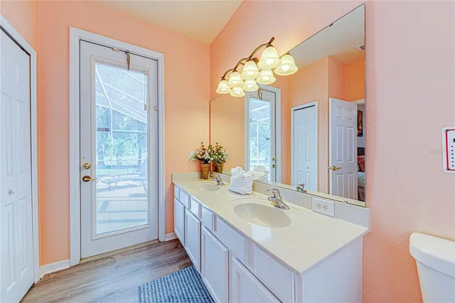 a en suite bathroom with a granite countertop sink a toilet and shower