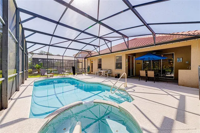 a living room with furniture and a dining table with projector