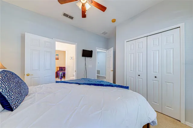 a bedroom with a bed and a chandelier