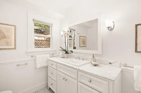 a bathroom with a sink vanity and a mirror