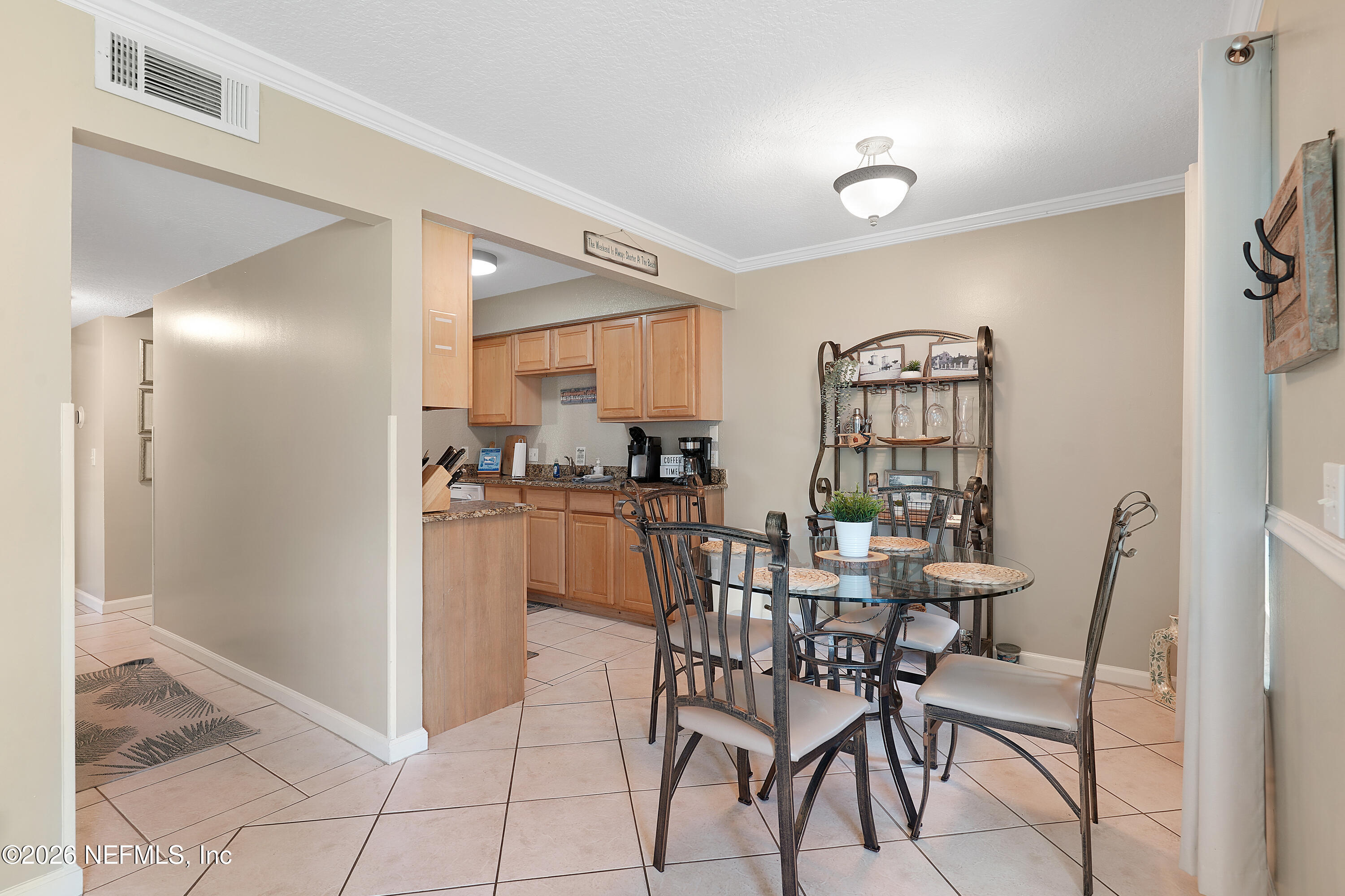 9 Clipper Court St. Augustine, FL 32080 - Photo 8 of 22 a dining room with stainless steel appliances kitchen island granite countertop a refrigerator and a sink