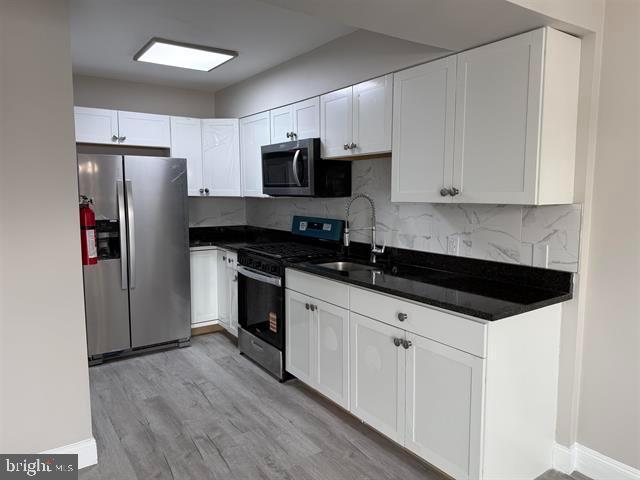1964 East Oak Road, Unit G2 Vineland, NJ 08361 - Photo 2 of 28 a kitchen with granite countertop a refrigerator sink and cabinets