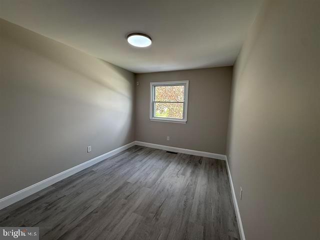 1964 East Oak Road, Unit G2 Vineland, NJ 08361 - Photo 22 of 28 a view of an empty room with wooden floor and a window