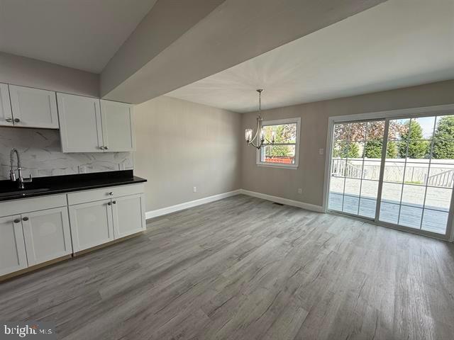 1964 East Oak Road, Unit G2 Vineland, NJ 08361 - Photo 5 of 28 a view of a kitchen with wooden floor and windows